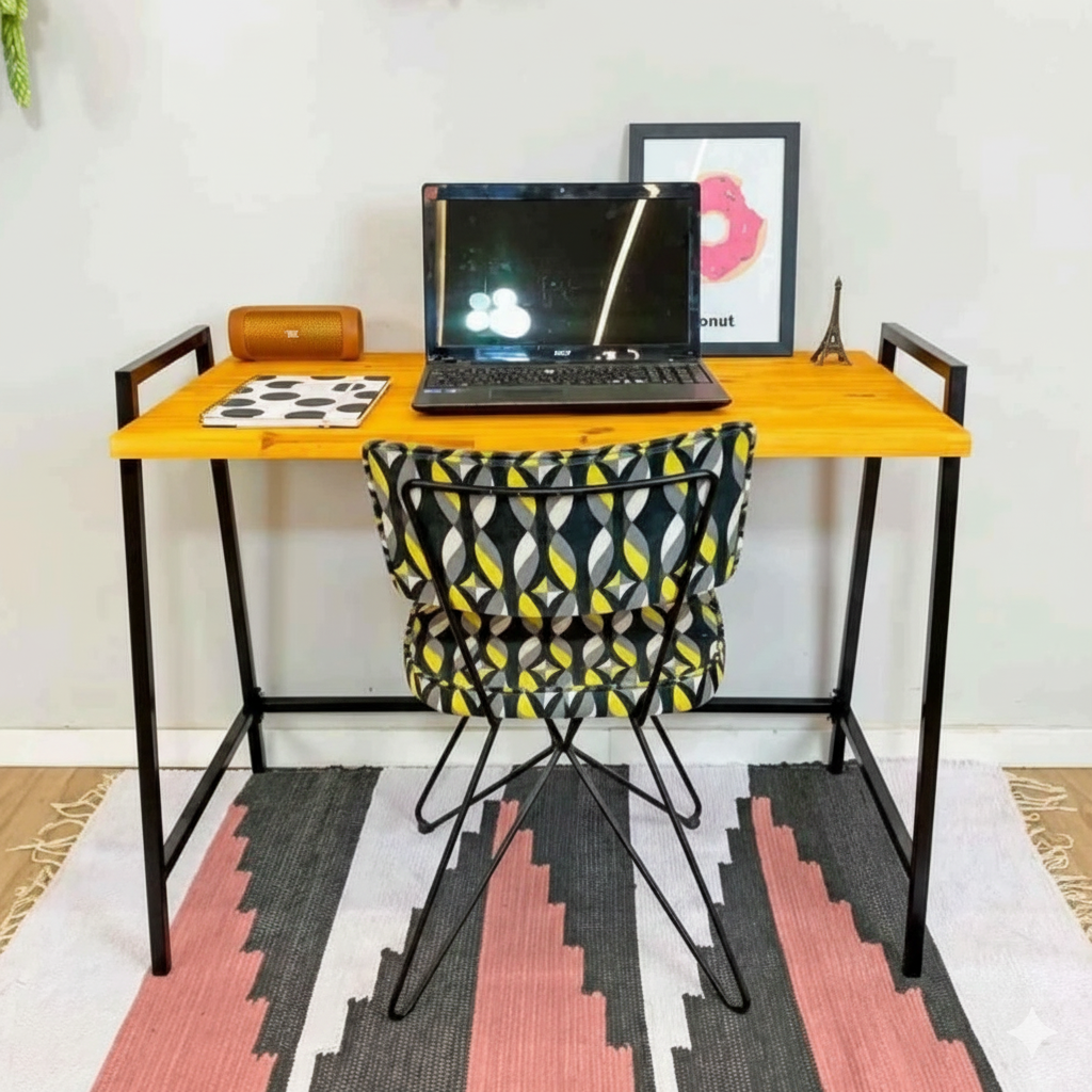 Small wooden desk with a laptop, chair, and decorative items on a patterned rug.